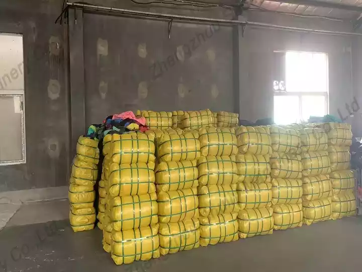 Compressed bales of second‑hand clothes